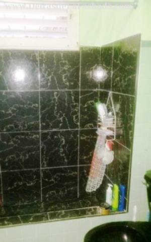 Bathroom clad in green and black slabs