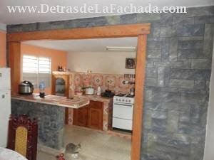 Pared decorada que divide comedor y cocina.