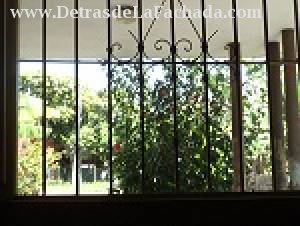 Window of room with view to road and Esc art